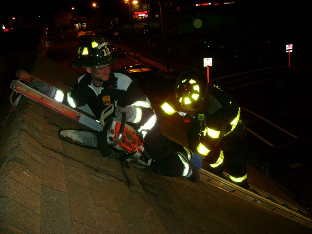 Truck Company Operations 10/07 - FF  Brady and FF Scott prepare to vent the roof 